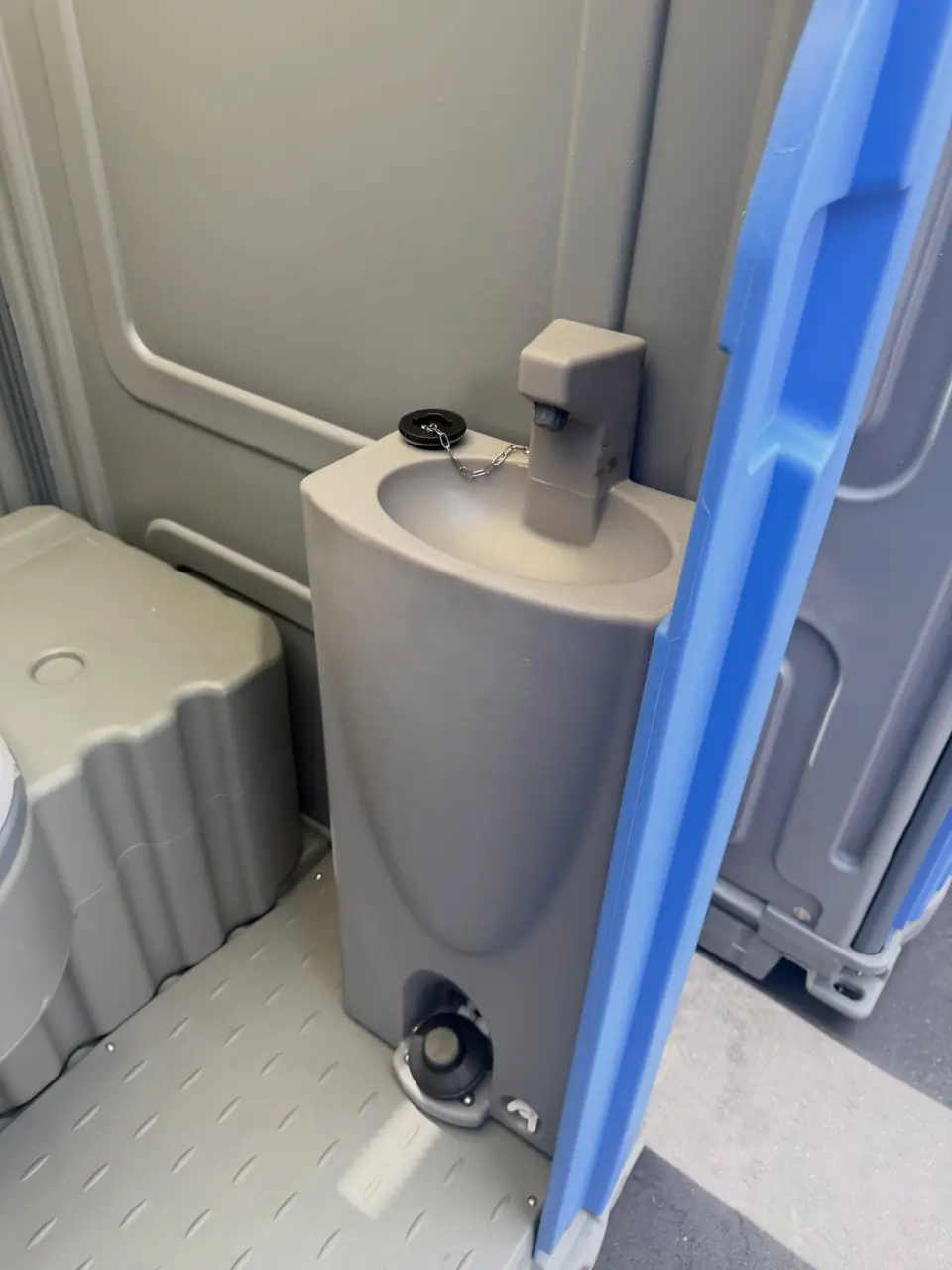 Sink with foot pump inside a deluxe porta potty