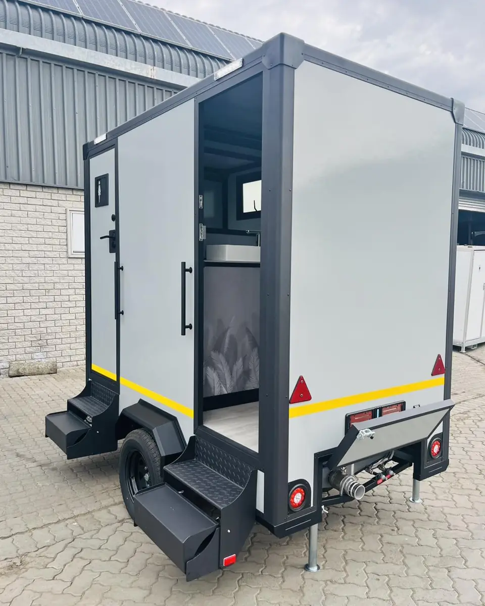 Restroom trailer showing steps, wheels and hitch