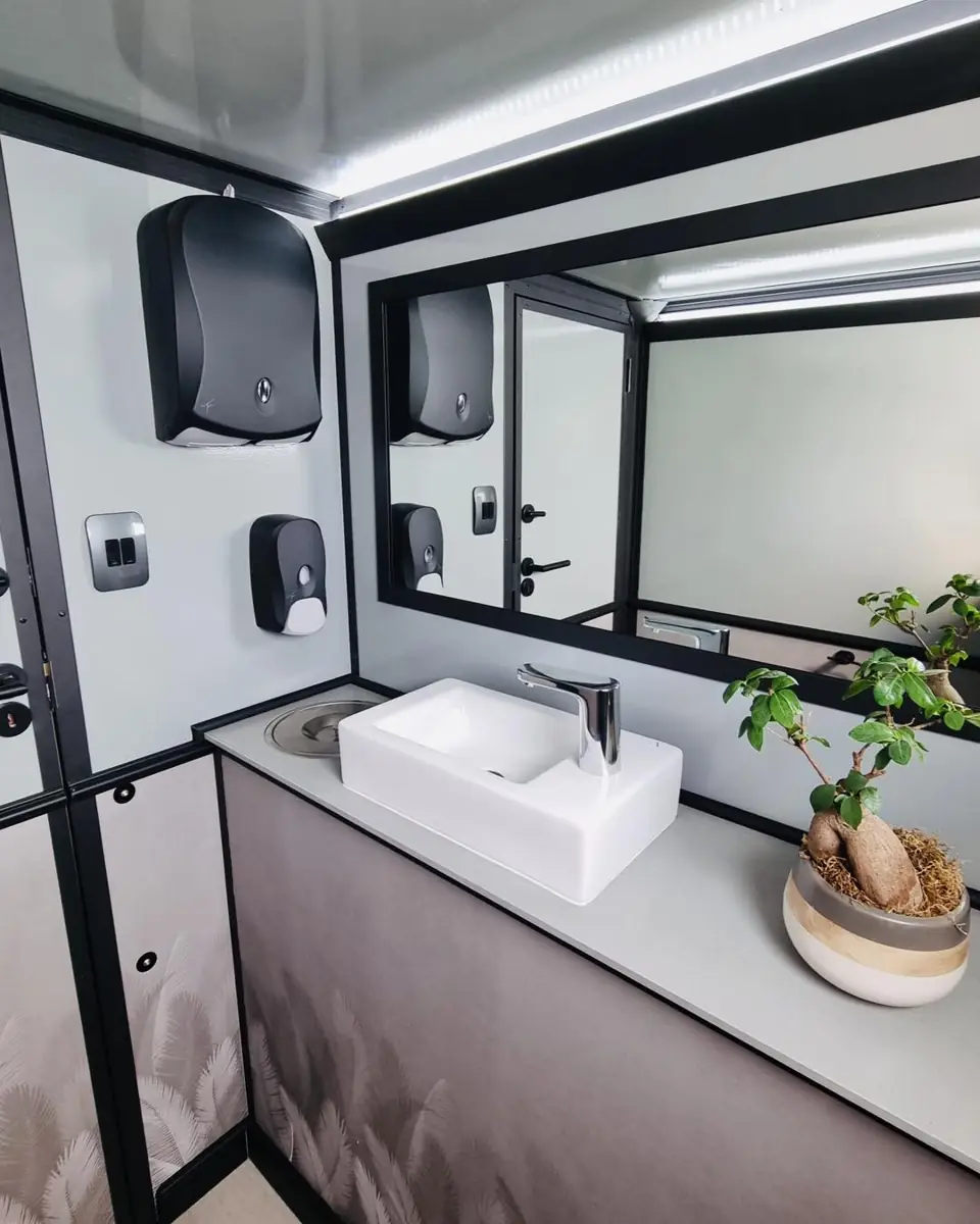 Restroom trailer vanity with mirror, soap and towel dispensers